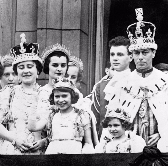 The then 11-year-old Elizabeth poses on the Buckingham Palace with her parents and sister Princess Margaret at her father King George VI's coronation.