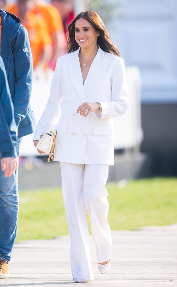 On day one, Meghan and Harry attended a reception for friends and family of Invictus Games competitors and the Duchess of Sussex's white Valentino suit is a lesson in power dressing.