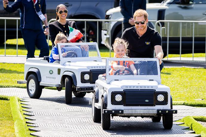 She and Harry looked completely at ease as they were driven around in mini Land Rovers!