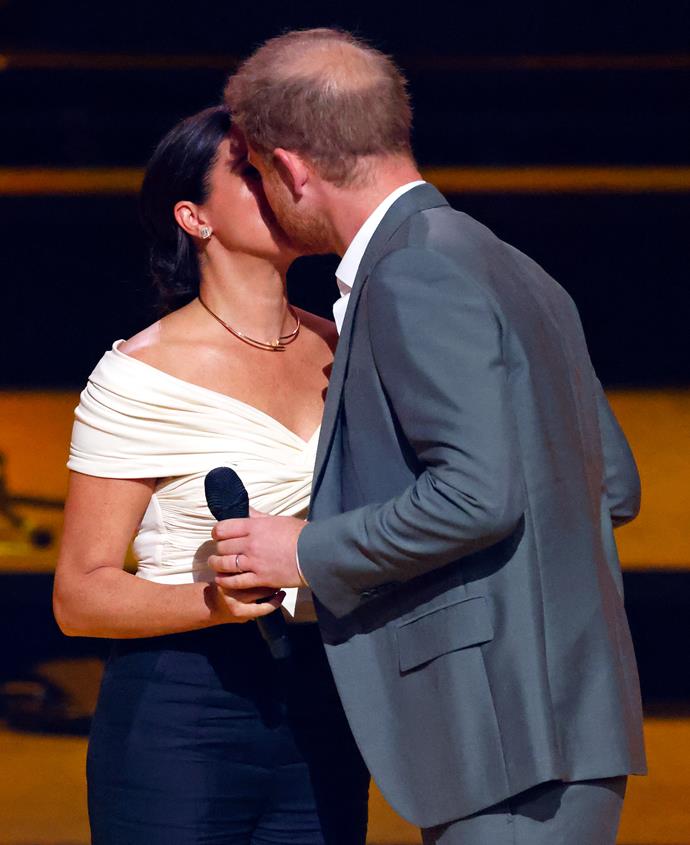 After introducing her "incredible" husband at the 2022 Invictus Games Opening Ceremony, Meghan shared a quick smooch with Harry on stage for all to see.