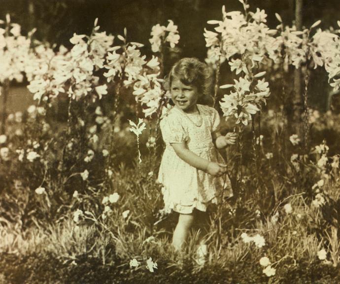 The then Princess Elizabeth picks flowers in the early 1930s in a photo snapped by her father George VI.