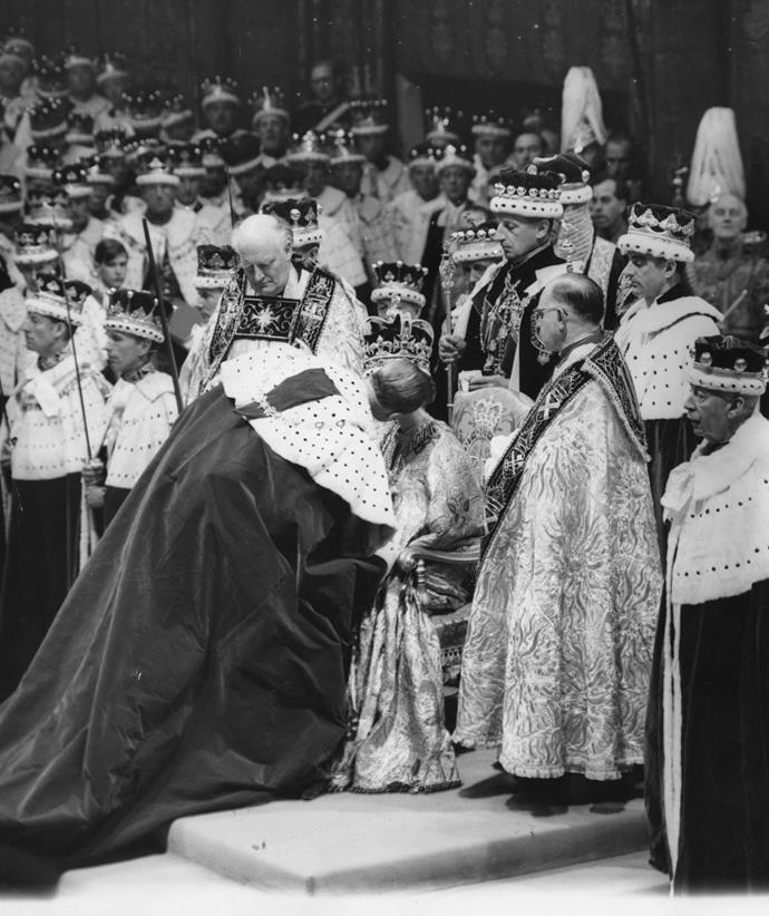 Prince Philip stole a tender moment at his wife's 1953 coronation, giving a kiss of homage to the Queen.