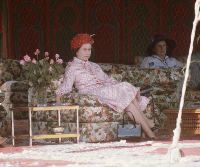 And here she looks unamused as she waits for King Hassan in Marrakech during her state visit to Morocco in 1980.