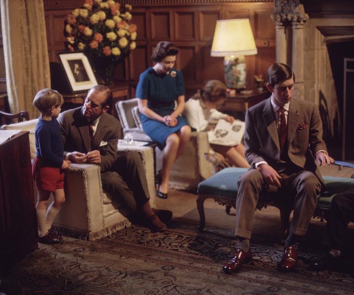 Years later, in 1969, the royal family were photorgaphed at home together, the Queen watching over daughter Anne's shoulder as she reads.