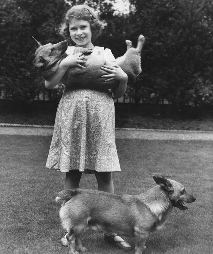 The princess grew up with her beloved corgi dogs at 145 Piccadilly, London, where this rare family photo was taken in July 1936.