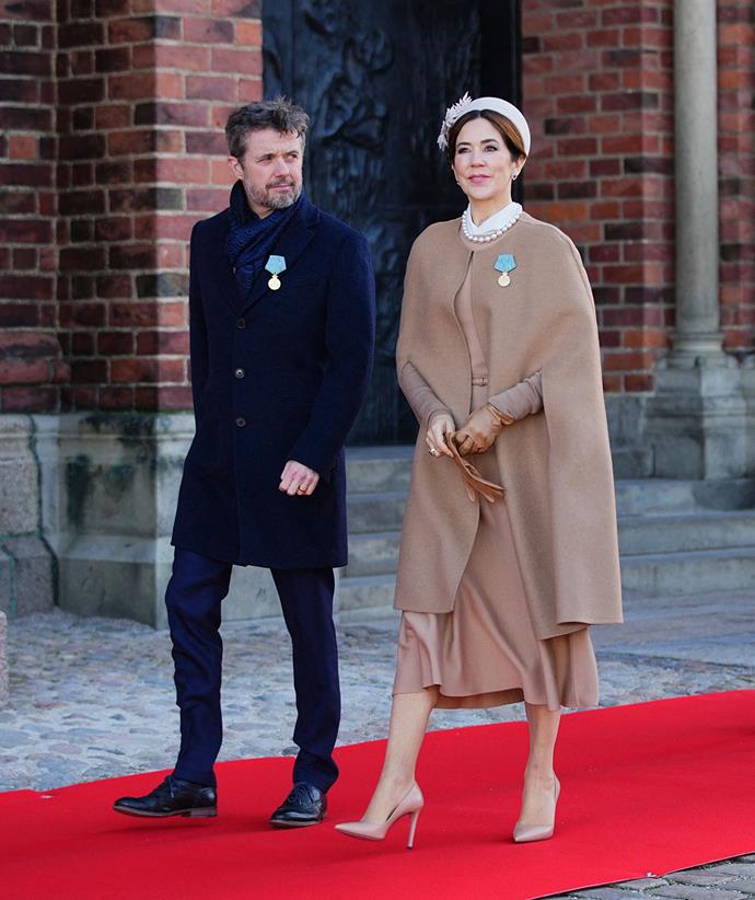 **January 2022, Denmark**
<br><br>
After a short bout of COVID-19, the princess was back in style for her first royal engagement of 2022, opting for a monochrome outfit with a Gabriela Hearst frock and matching Oscar de la Renta cape.