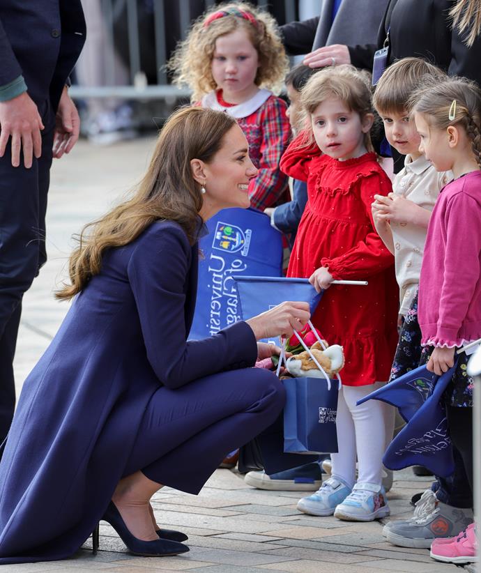 She crouched down to chat with a few little girls.