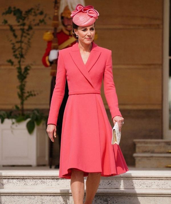 That same month, Catherine, Duchess of Cambridge mesmerised onlookers as she [attended a Royal Garden Party](https://www.nowtolove.com.au/fashion/fashion-news/kate-middleton-garden-party-outfits-73397|target="_blank") at Buckingham Palace, sporting a vibrant coral pink coat midi dress with long sleeves, a belted waist and flowing skirt.