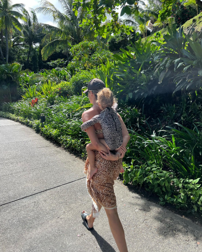 Frankie hitched a ride on mum during the family holiday.