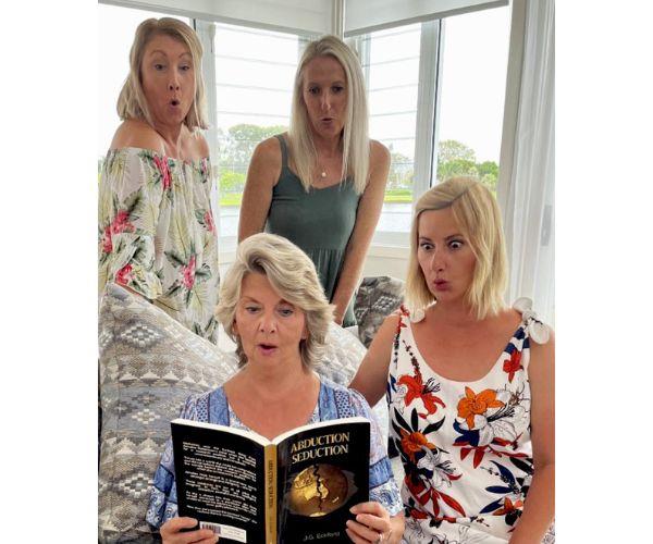 Judy reads her book with her daughters Prue, Jane and Abigail.