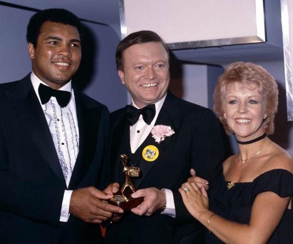 Bert and his [wife Patti Newton](https://www.nowtolove.com.au/parenting/celebrity-families/bert-newton-family-63984|target="_blank") with legendary boxer Muhammad Ali at the Logies in 1979.