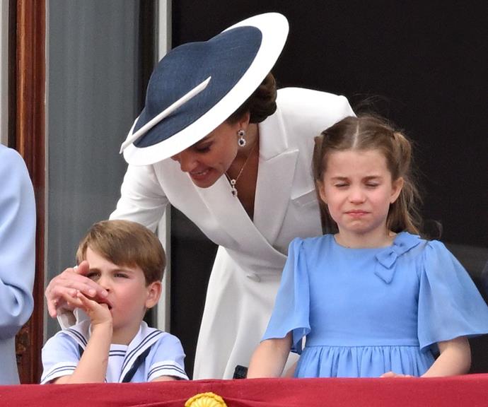 Even though Kate was standing on the Buckingham Palace balcony, she still had to keep her kids entertained and in line with royal protocol.