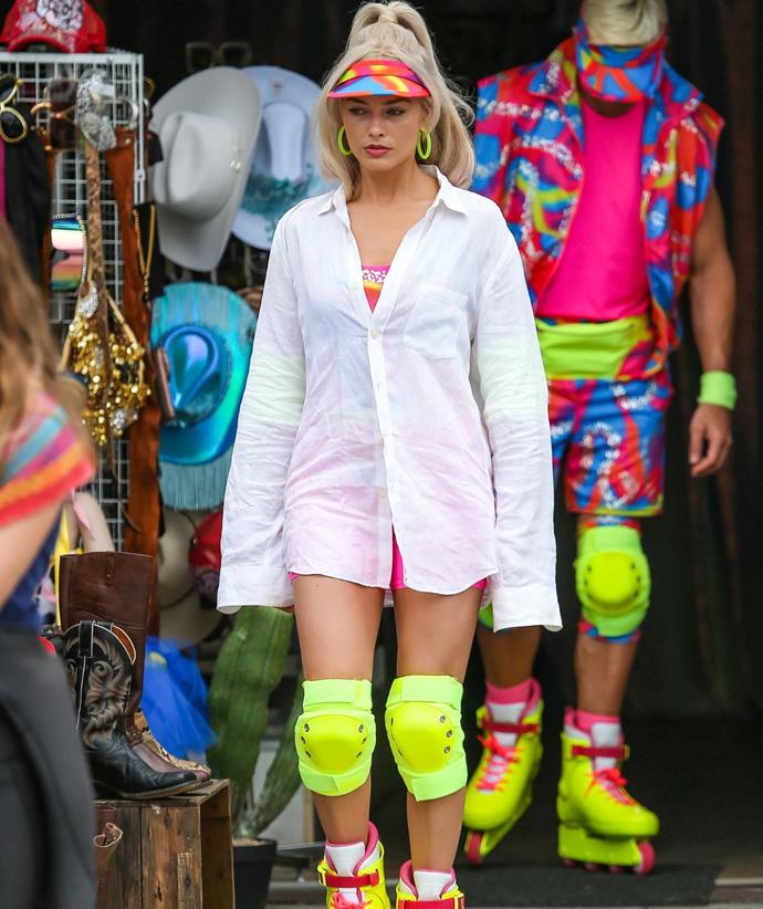 The internet set alight when the first pics of Margot filming the Barbie movie with her leading man Ryan Gosling (in the colourful combo behind her). Of course, we didn't need to see it to believe she would be perfect for the role - but seeing her in costume took the hype to another level.