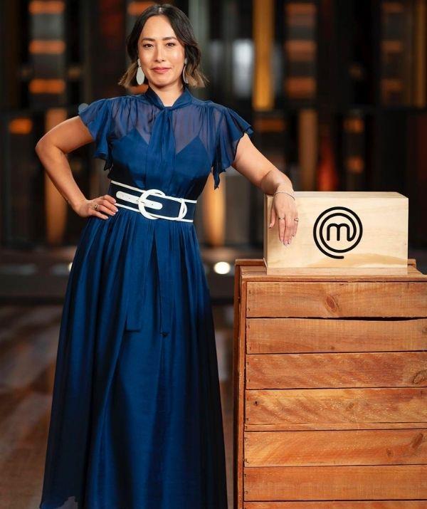 She always pulls off navy! This floor length Leo Lin dress with a sheer top and matching belt were a stand out during *MasterChef* 2022.