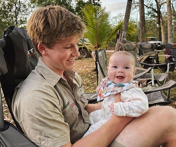 Grace couldn't have looked happier hanging out on her "funcle" Robert's lap during their camping trip. "She's lovin' life up here on our crocodile research expedition!" he penned.