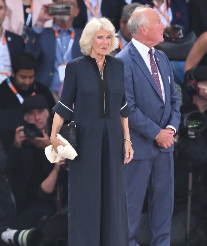 The Duchess of Cornwall opted for a subdued ensemble, choosing a floor-length navy dress with cropped sleeves.