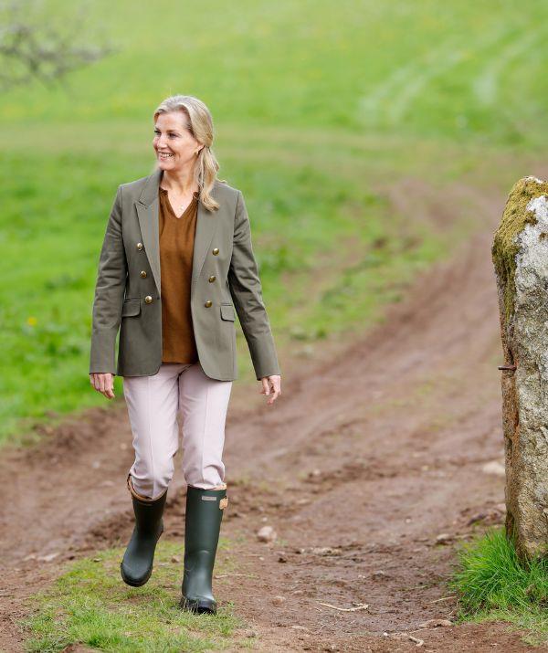 Keen horse rider Sophie looked equestrian chic during this visit to Shallowford farm in May 2022. With a brown smock top, cream trousers, a green military-style jacket and Ariat wellington boots, the royal looked ready for the racetrack.