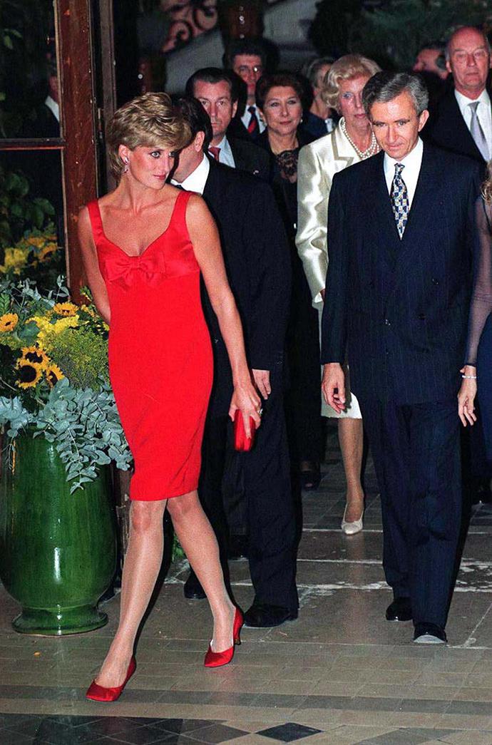 While in Paris, Diana dazzled in a scarlet Christian Lacroix gown for a gala dinner in September 1995.