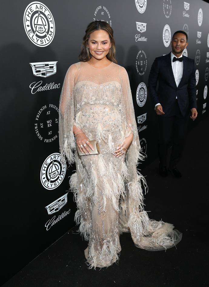 Chrissy Teigen looking glamorous in this Pamella Roland gown at The Art Of Elysium's 11th Annual Celebration. We see you admiring the view there John.