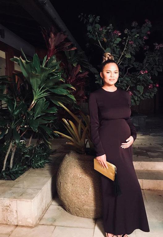 Chrissy looks stunning in this black fitted gown that shows off her gorgeous bump.