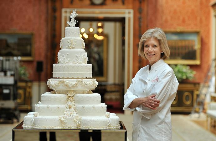 Fiona Cairns stands next to the grand eight-tier cake she created for William and Kate's 2011 wedding.