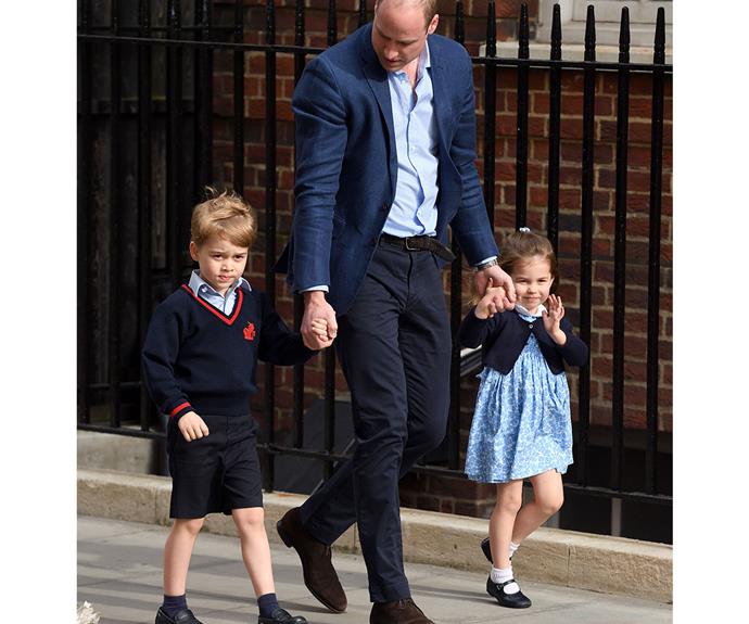 Prince George was wary of photographers as he walked with his dad and sister on their way to meet Prince Louis.