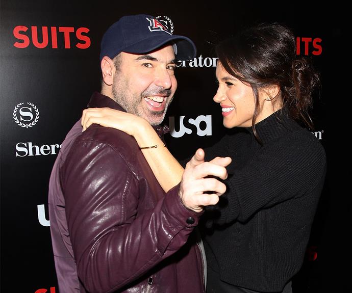 Here's Meghan goofing around at the premiere of *Suits* season five with her co-star Rick Hoffman.