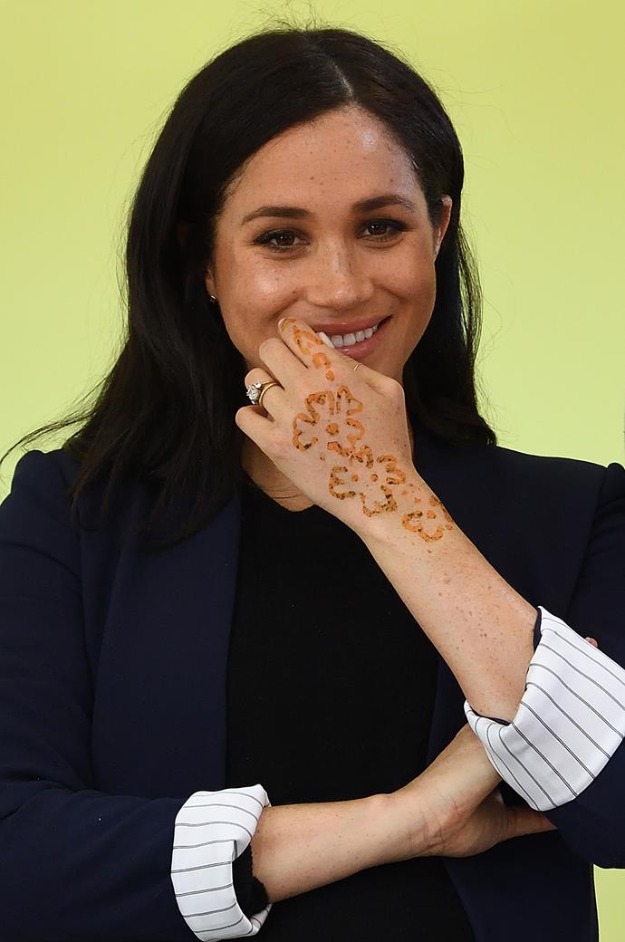 Duchess Meghan shows off her henna tattoo that she received while visiting a boarding house for girls by the Moroccan NGO 'Education for All'. *(Image: Getty)*