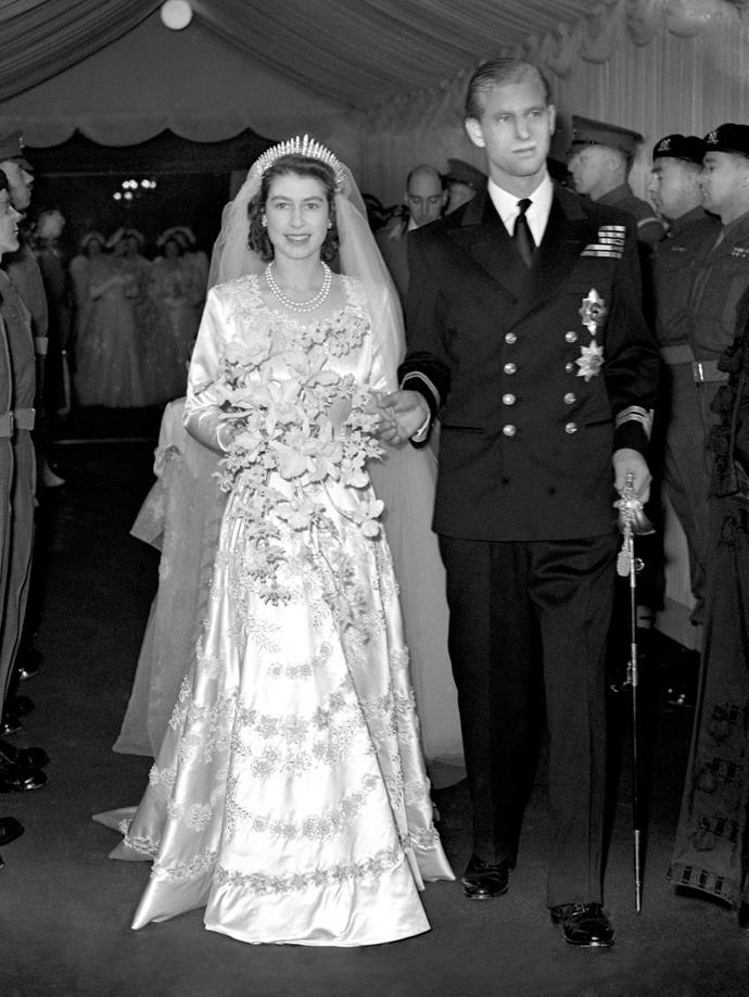 **Princess Elizabeth, 20 November 1947**
<br><br>
Before she became Queen, Princess Elizabeth married Prince Philip at Westminster Abbey on November 20,1947.
<br><br>
Elizabeth's beautiful wedding gown was hand-embroidered with more than 10,000 pearls and crystals and designed by Sir Norman Hartnell, who cited Boticelli's painting Primavera as his inspiration.
<br><br>
Her skirt was made of Duchesse satin and her long sleeves were embroidered with garlands of roses in raised pearls entwined with ears of wheat in crystals and pearls.
<br><br>
A 14-foot-long ivory silk tulle train completed the gown, embroidered with rose and wheat motifs.