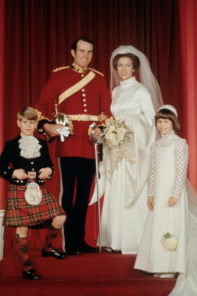 **Princess Anne, 14 November 1973**
<br><br>
For her first marriage held at Westminster Abbey to Captain Mark Phillips, the Princess Royal opted for an Elizabethan-style gown [designed by Maureen Baker](http://royalcentral.co.uk/blogs/the-wedding-dresses-of-princess-anne-101962|target="_blank"|rel="nofollow").
<br><br>
The fitted dress featured a fitted bodice, trumpet sleeves and high-neck with a flared skirt that flowed out to a seven-foot train.
<br><br>
The dress had lines of pearls sewn across the bodice and floral motifs on the back.