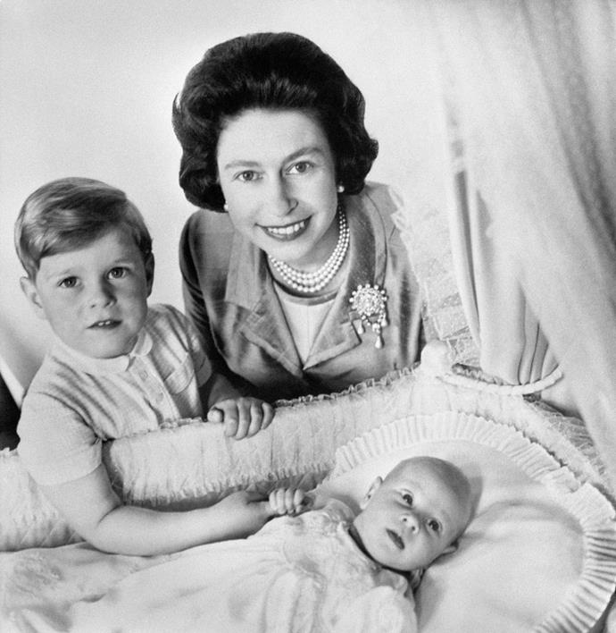 Four-year-old Prince Andrew with Queen Elizabeth and a newborn Prince Edward. *(Image: Getty)*