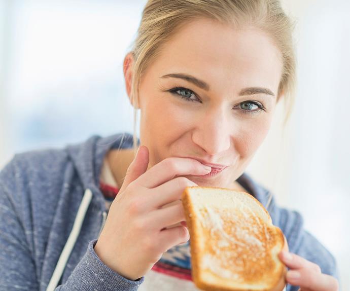 woman eating toast with butter