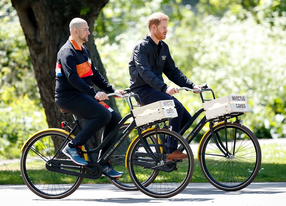 Prince Harry rides around the park where the Invictus Games will be held next year, with former soldier Dennis van der Stroon. *(Image: Getty)*