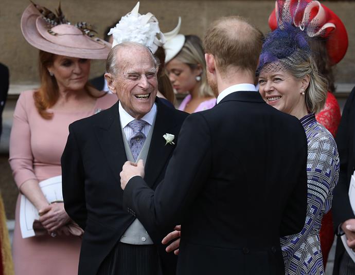 Prince Philip shares a laugh with his grandson Prince Harry and Lady Helen Taylor. *(Image: Getty)*