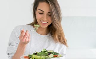 Brunette woman eating a salad