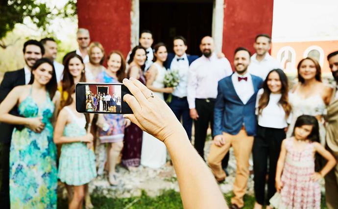 A wedding photographer has sparked heated debate after urging wedding guests to put away their phones