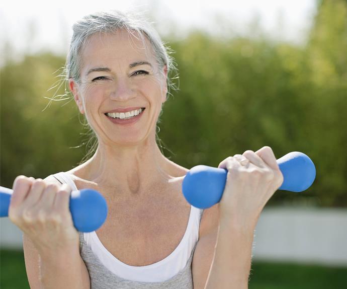 middle aged woman doing hand weights