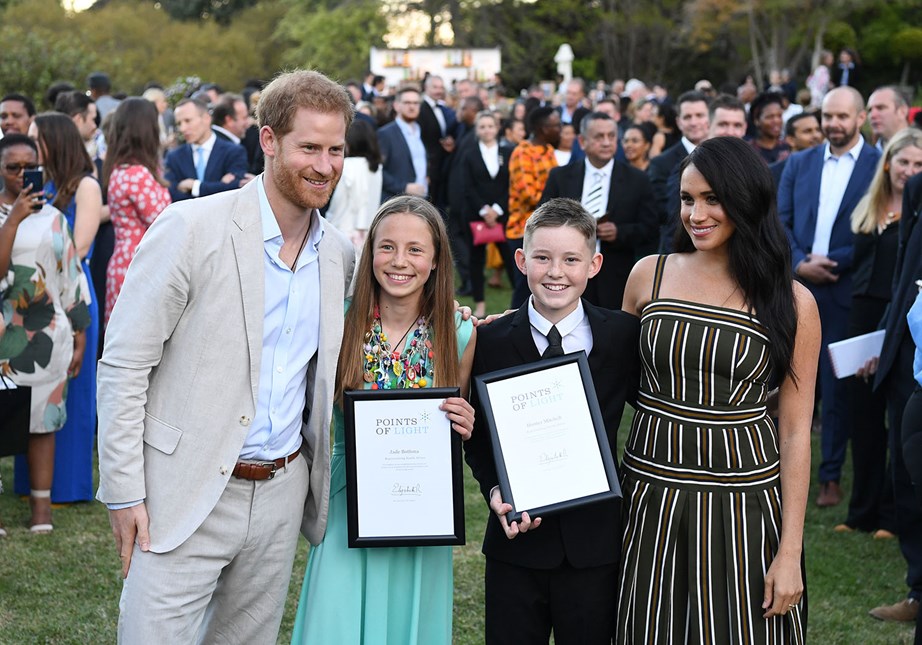 Harry and Meghan awarded young volunteers, Jade and Hunter, Commonwealth Points of Light awards. *(Image: Getty)*