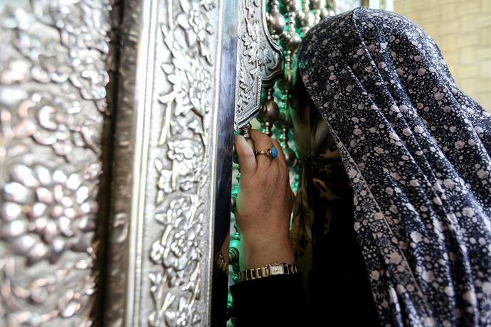 Woman praying at Emamzadeh Saleh.