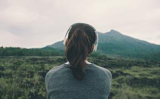 woman listening to music in nature