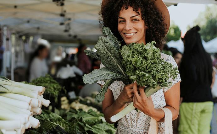 woman shopping for kale at farmer's market