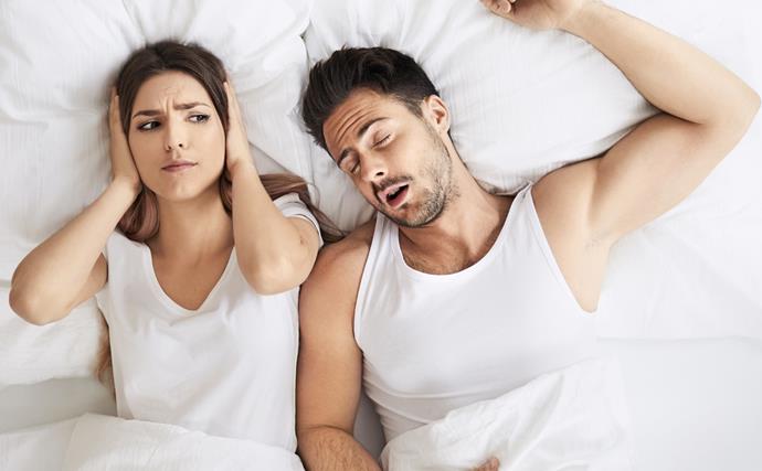 Couple in bed, man snoring woman wide awake