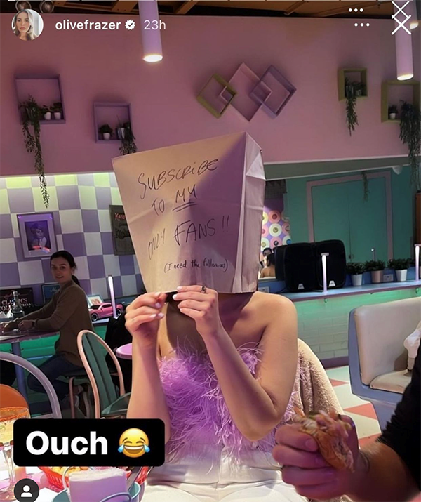 Olivia shared a photo of herself at a restaurant with a paper bag over her head that read: "Subscribe to MY OnlyFans (I need the followers)" (Image: Instagram)