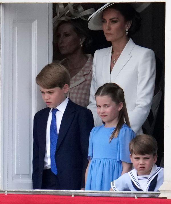 The siblings stood on the balcony with their mother. *(Image: Getty)*