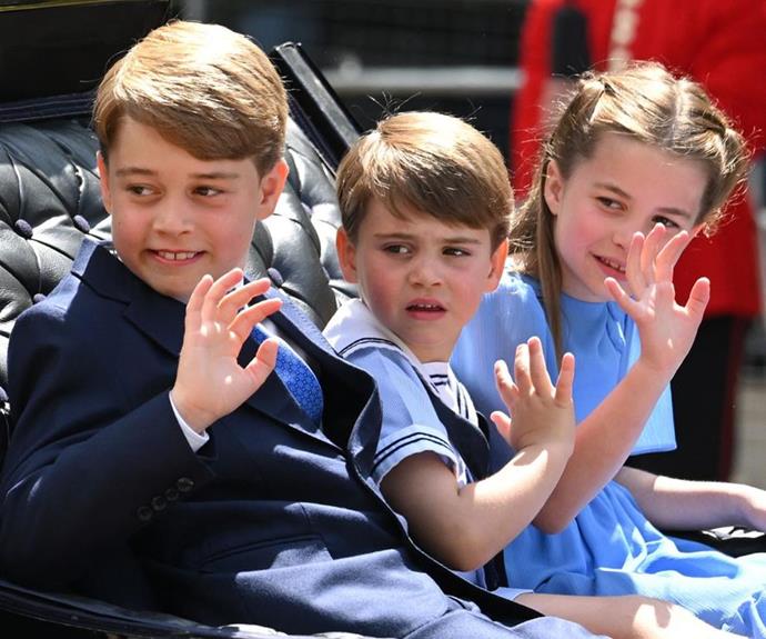 The three siblings waved from their carriage on the way to Buckingham Palace. *(Image: Getty)*