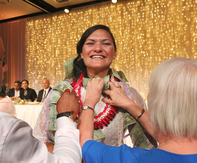 In keeping with Tongan tradition, guests shower the couple with money for their families.