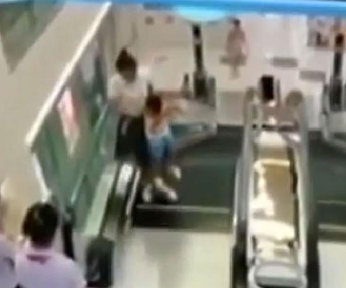 A mother has died after saving her toddler from faulty escalator.