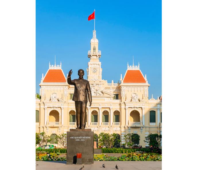 A statue of President Ho Chi Minh stands outside Saigon City Hall.