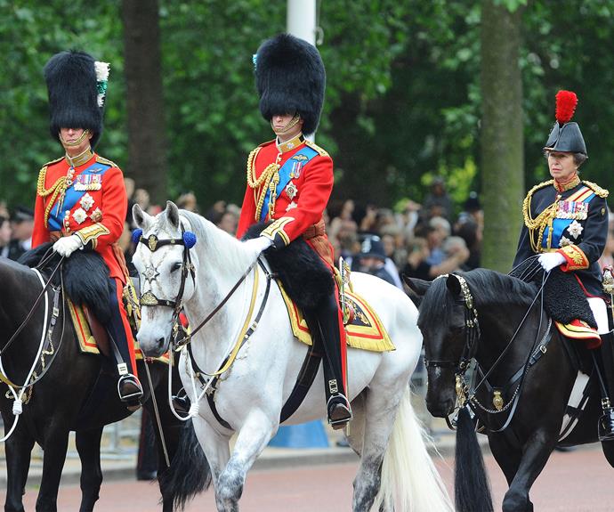 Riding in on a horse is Prince Charles, Prince William and Princess Anne.