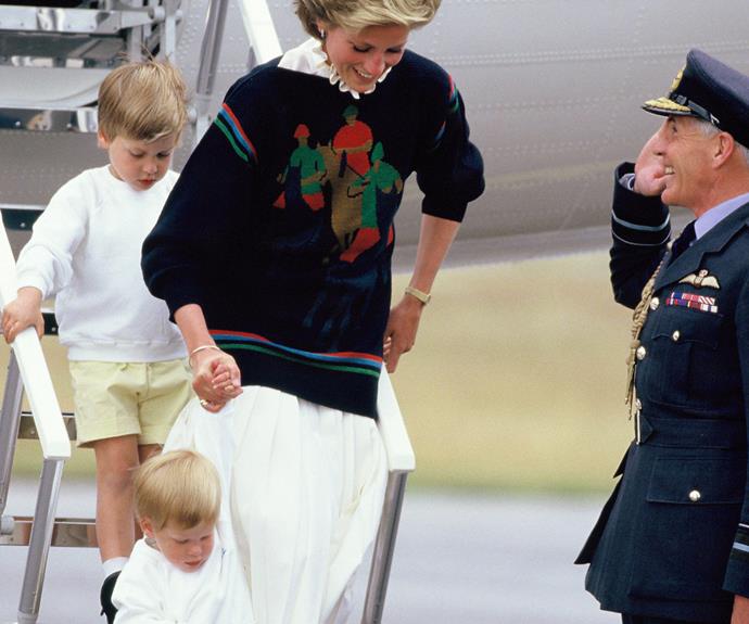 Diana giggles as she helps Harry down the stairs of the plane.